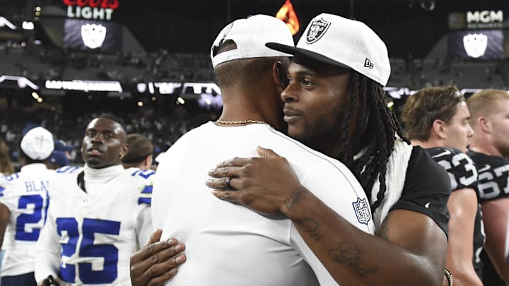 Dallas Cowboys quarterback Dak Prescott hugs Las Vegas Raiders wide receiver Davante Adams postgame at Allegiant Stadium. 