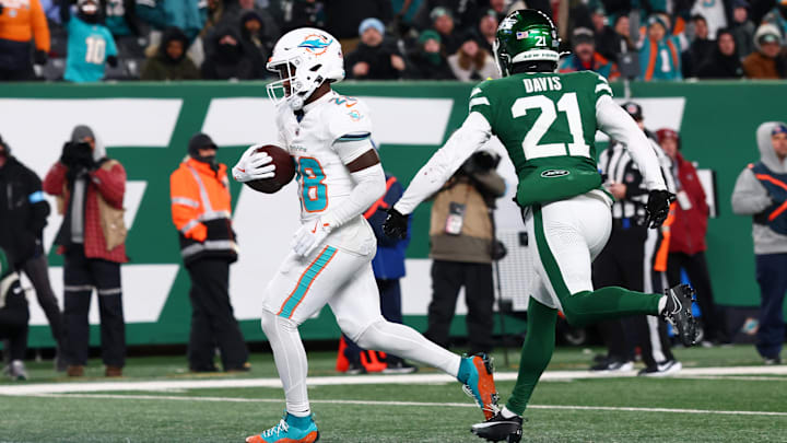 Miami Dolphins running back De'Von Achane (28) scores a touchdown during the fourth quarter of their game against the New York Jets at MetLife Stadium in the season finale.