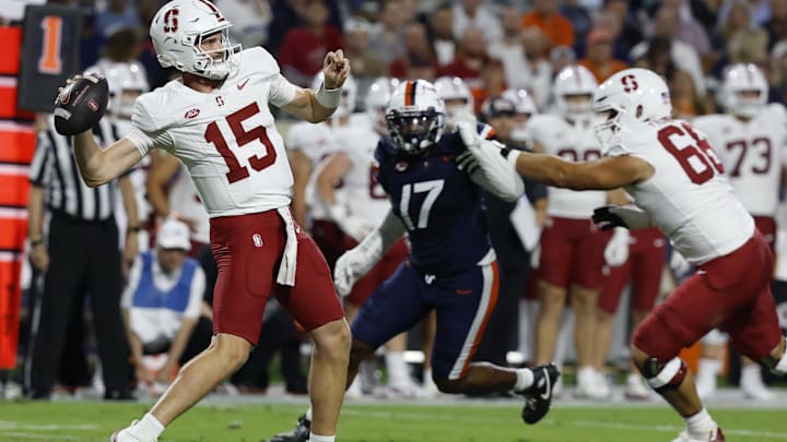 Sep 20, 2025; Charlottesville, Virginia, USA; Stanford Cardinal quarterback Ben Gulbranson (15) throws a sixty yard pass to Cardinal wide receiver Bryce Farrell (not pictured) as Virginia Cavaliers defensive end Mitchell Melton (17) defends during the first quarter at Scott Stadium. Mandatory Credit: Geoff Burke-Imagn Images Sep 20, 2025; Charlottesville, Virginia, USA; Stanford Cardinal quarterback Ben Gulbranson (15) throws a sixty yard pass to Cardinal wide receiver Bryce Farrell (not pictured) as Virginia Cavaliers defensive end Mitchell Melton (17) defends during the first quarter at Scott Stadium. Mandatory Credit: Geoff Burke-Imagn Images