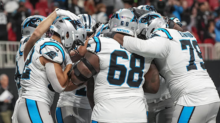 Jan 5, 2025; Atlanta, Georgia, USA; Carolina Panthers running back Miles Sanders (6) reacts with teammates after scoring the game winning touchdown against the Atlanta Falcons in overtime at Mercedes-Benz Stadium. Mandatory Credit: Dale Zanine-Imagn Images Jan 5, 2025; Atlanta, Georgia, USA; Carolina Panthers running back Miles Sanders (6) reacts with teammates after scoring the game winning touchdown against the Atlanta Falcons in overtime at Mercedes-Benz Stadium. Mandatory Credit: Dale Zanine-Imagn Images