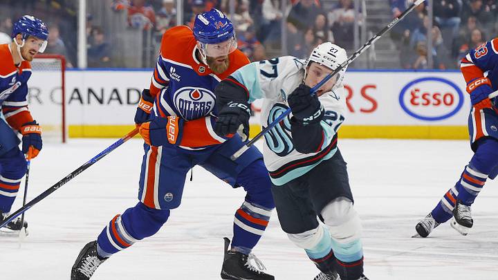 Mar 31, 2026; Edmonton, Alberta, CAN; Edmonton Oilers defensemen Mattias Ekholm (14) pulls down Seattle Kraken forward Berkly Catton (27) during the second period at Rogers Place. Mandatory Credit: Perry Nelson-Imagn Images