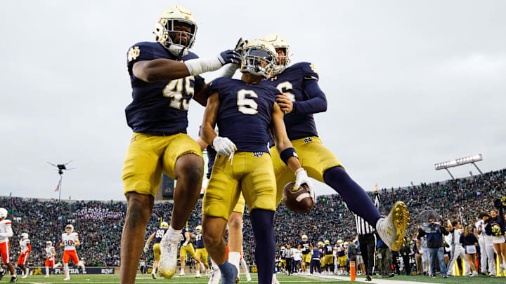 Notre Dame defensive lineman Kobi Onyiuke (45), wide receiver Jordan Faison (6) and wide receiver Alex Whitman (86) celebrate a Faison touchdown on fake punt play that would later be called back during a NCAA college football game against Virginia at Notre Dame Stadium on Saturday, Nov. 16, 2024, in South Bend.
