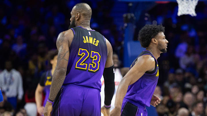 Jan 28, 2025; Philadelphia, Pennsylvania, USA; Los Angeles Lakers forward LeBron James (23) and guard Bronny James (9) slap hands before a substitution during the fourth quarter against the Philadelphia 76ers at Wells Fargo Center. Mandatory Credit: Bill Streicher-Imagn Images