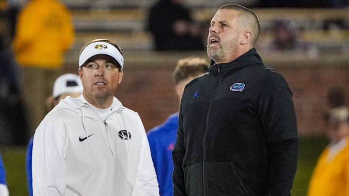 Nov 18, 2023; Columbia, Missouri, USA; Missouri Tigers head coach Eli Drinkwitz, left, talks with Florida Gators head coach Billy Napier prior to a game at Faurot Field at Memorial Stadium. Mandatory Credit: Denny Medley-Imagn Images