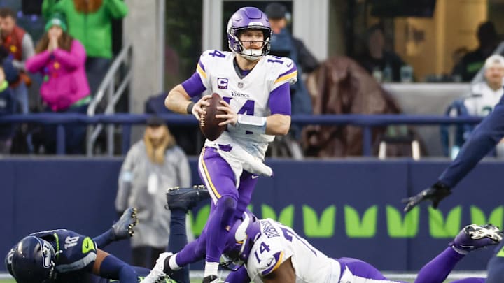 Dec 22, 2024; Seattle, Washington, USA; Minnesota Vikings quarterback Sam Darnold (14) scrambles out of the pocket against the Seattle Seahawks during the fourth quarter at Lumen Field.