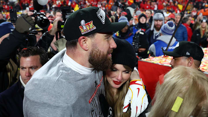 Recording artist Taylor Swift  and Kansas City Chiefs tight end Travis Kelce (87) react after the AFC Championship game against the Buffalo Bills at GEHA Field at Arrowhead Stadium.