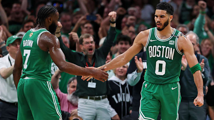 Boston Celtics forward Jayson Tatum (0) celebrates with guard Jaylen Brown (7) after a play against the Dallas Mavericks