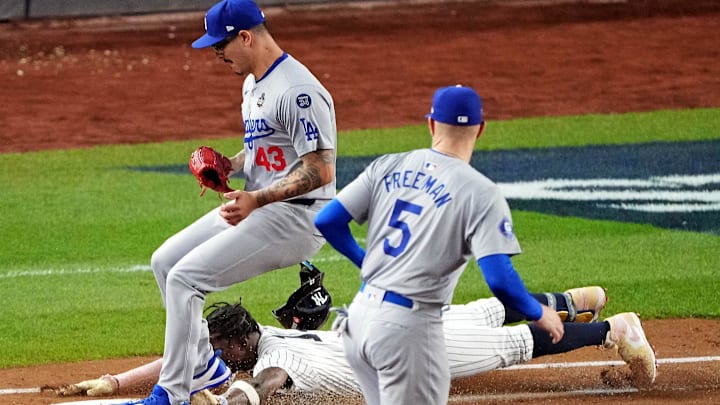New York Yankees third baseman Jazz Chisholm Jr. (13) dives into first base to try to beat the throw from Los Angeles Dodgers first baseman Freddie Freeman (5) to pitcher Anthony Banda (43) during the second inning in game four of the 2024 MLB World Series at Yankee Stadium on Oct. 30, 2024.