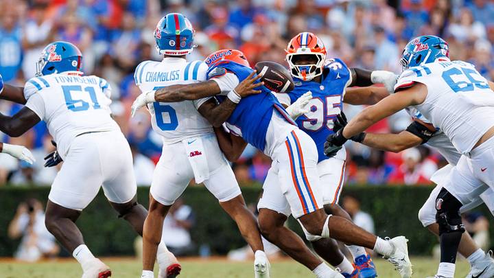 Sep 26, 2026; Gainesville, Florida, USA; Florida Gators jack Jayden Woods (0) tackles Mississippi Rebels quarterback Trinidad Chambliss (6) causing him to fumble the ball during the second half at Ben Hill Griffin Stadium. Mandatory Credit: Matt Pendleton-Imagn Images Sep 26, 2026; Gainesville, Florida, USA; Florida Gators jack Jayden Woods (0) tackles Mississippi Rebels quarterback Trinidad Chambliss (6) causing him to fumble the ball during the second half at Ben Hill Griffin Stadium. Mandatory Credit: Matt Pendleton-Imagn Images