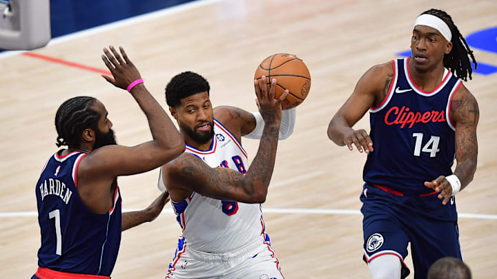 Nov 6, 2024; Inglewood, California, USA; Philadelphia 76ers forward Paul George (8) moves to the basket against Los Angeles Clippers guard James Harden (1) and guard Terance Mann (14) during the second half at Intuit Dome. Mandatory Credit: Gary A. Vasquez-Imagn Images