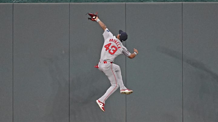 Aug 5, 2024; Kansas City, Missouri, USA;  Boston Red Sox center fielder Ceddanne Rafaela (43) catches a fly ball in front of the center field wall against Kansas City Royals Maikel Garcia (not pictured) in the fifth inning at Kauffman Stadium. Mandatory Credit: Peter Aiken-Imagn Images
