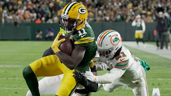 Green Bay Packers wide receiver Jayden Reed (11) scores a touchdown on a reception during the second quarter of their game against the Miami Dolphins Thursday, November 28, 2024 at Lambeau Field in Green Bay, Wisconsin. Green Bay Packers wide receiver Jayden Reed (11) scores a touchdown on a reception during the second quarter of their game against the Miami Dolphins Thursday, November 28, 2024 at Lambeau Field in Green Bay, Wisconsin.