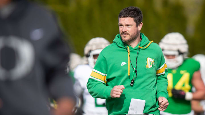 Oregon head coach Dan Lanning runs during practice with the Ducks.