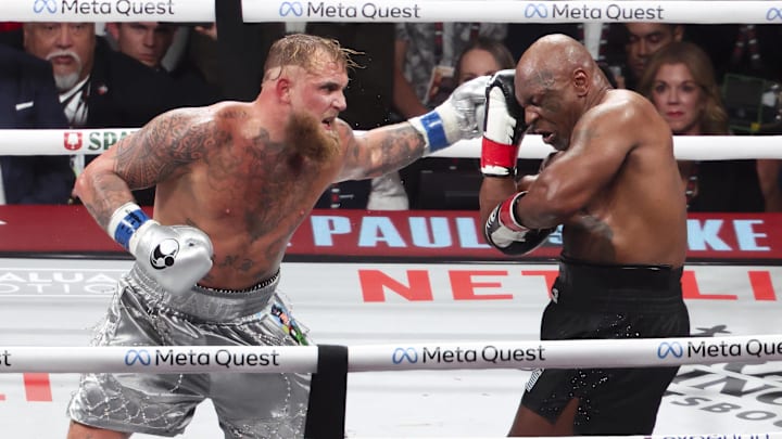 Nov 15, 2024; Arlington, Texas, UNITED STATES;  Mike Tyson (black gloves) fights Jake Paul (silver gloves) at AT&T Stadium. Mandatory Credit: Kevin Jairaj-Imagn Images