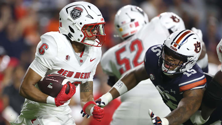 Sep 14, 2024; Auburn, Alabama, USA; Auburn Tigers defensive lineman Keldric Faulk (15) dives to tackle New Mexico Lobos running back Eli Sanders (6) during the second quarter at Jordan-Hare Stadium. Mandatory Credit: John Reed-Imagn Images