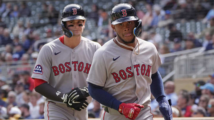 Apr 15, 2026; Minneapolis, Minnesota, USA; Boston Red Sox right fielder Roman Anthony (left) and center fielder Ceddanne Rafaela return to the dugout after scoring against the Minnesota Twins in the sixth inning on a double by shortstop Trevor Story (not pictured) at Target Field. Mandatory Credit: Bruce Kluckhohn-Imagn Images