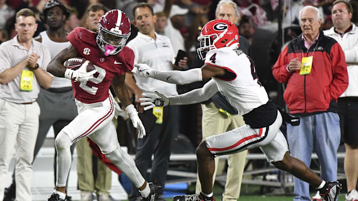 Alabama Crimson Tide wide receiver Ryan Williams (2) breaks a tackle by Georgia Bulldogs defensive back KJ Bolden (4) 
