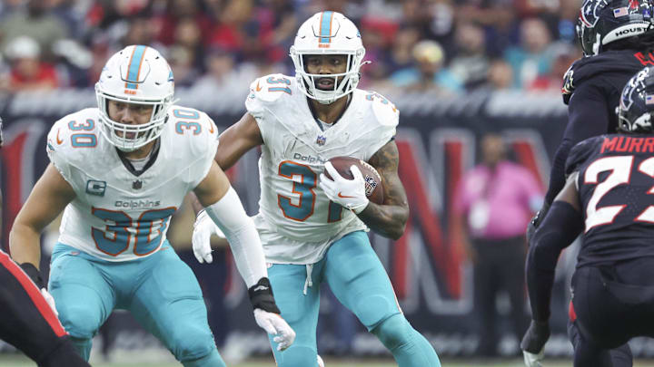 Dec 15, 2024; Houston, Texas, USA; Miami Dolphins running back Raheem Mostert (31) runs with the ball during the game against the Houston Texans at NRG Stadium. Mandatory Credit: Troy Taormina-Imagn Images