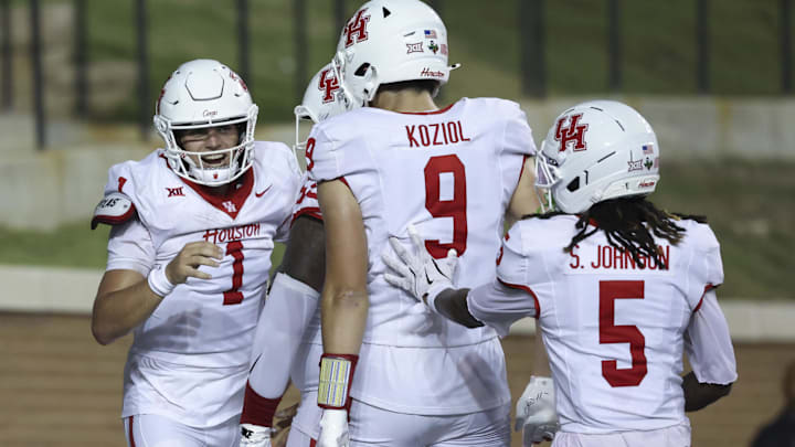 Houston Cougars quarterback Conner Weigman celebrates with teammates after scoring a touchdown during the third quarter against the Rice Owls at Rice Stadium. 