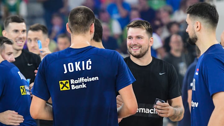 Nikola Jokic of Serbia and Luka Doncic of Slovenia shake...