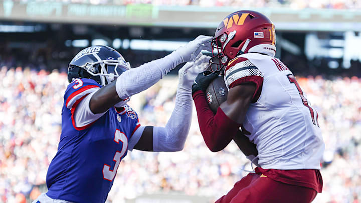 Nov 3, 2024; East Rutherford, New Jersey, USA; Washington Commanders wide receiver Terry McLaurin (17) catches a touchdown pass as New York Giants cornerback Deonte Banks (3) defends during the first half at MetLife Stadium.  