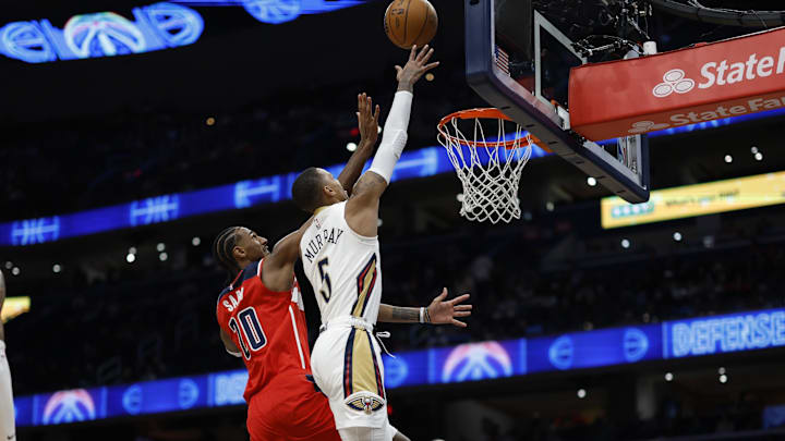 Jan 5, 2025; Washington, District of Columbia, USA; New Orleans Pelicans guard Dejounte Murray (5) shoots the ball as Washington Wizards forward Alexandre Sarr (20) defends in the third quarter at Capital One Arena. Mandatory Credit: Geoff Burke-Imagn Images