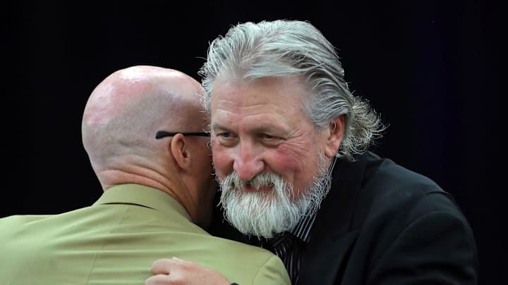 Former Zips basketball coach Bob Huggins, facing, hugs current coach John Groce after speaking during the Akron Basketball reunion and celebration at the University of Akron student union, Saturday, July 27, 2024, in Akron, Ohio.