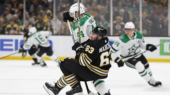 Feb 19, 2024; Boston, Massachusetts, USA; Boston Bruins left wing Brad Marchand (63) is dumped at