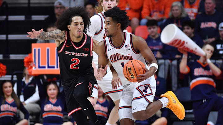 Jan 8, 2026; Champaign, Illinois, USA;  Illinois Fighting Illini guard Brandon Lee (1) drives the ball around Rutgers Scarlet Knights guard Lino Mark (2) during the second half at State Farm Center. Mandatory Credit: Ron Johnson-Imagn Images