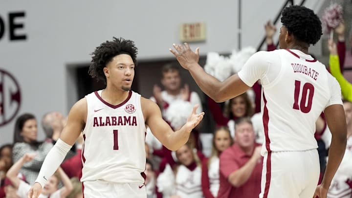 Feb 1, 2025; Tuscaloosa, AL, USA;  Alabama Crimson Tide guard Mark Sears (1) celebrates with forward Mouhamed Dioubate (10) during a timeout against the Georgia Bulldogs at Coleman Coliseum. Alabama won 90-69. Mandatory Credit: Gary Cosby Jr/USA TODAY Network via Imagn Images