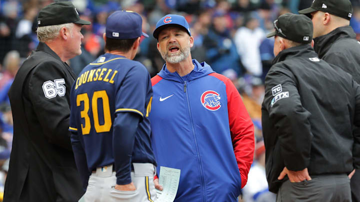 Chicago Cubs manager David Ross and Milwaukee Brewers manager Craig Counsell (30) meet before their game in April 2022 at Wrigley Field in Chicago, Ill.