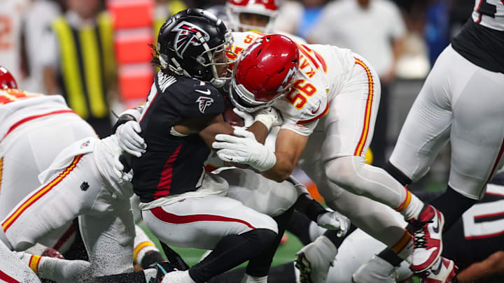 Robinson is tackled by Kansas City Chiefs defensive end George Karlaftis (56) in the first quarter at Mercedes-Benz Stadium.