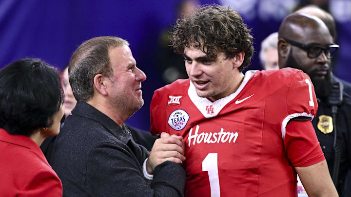 Houston Cougars quarterback Conner Weigman (1) is greeted by United States ambassador to Italy and San Marino Tillman Fertitta after the game against the Louisiana State Tigers at NRG Stadium.