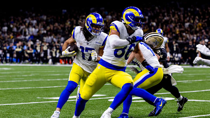 Dec 1, 2024; New Orleans, Louisiana, USA;  Los Angeles Rams wide receiver Puka Nacua (17) rushes in for a touchdown against New Orleans Saints linebacker Pete Werner (20) during the second half at Caesars Superdome. Mandatory Credit: Stephen Lew-Imagn Images