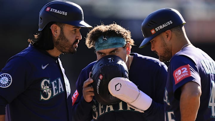 Mariners third baseman Eugenio Suarez, left, first baseman Josh Naylor and third base coach Kristopher Negron converse during Tigers pitching change during the fourth inning of Game 4 of ALDS at Comerica Park in Detroit on Wednesday, Oct. 8, 2025. Mariners third baseman Eugenio Suarez, left, first baseman Josh Naylor and third base coach Kristopher Negron converse during Tigers pitching change during the fourth inning of Game 4 of ALDS at Comerica Park in Detroit on Wednesday, Oct. 8, 2025.