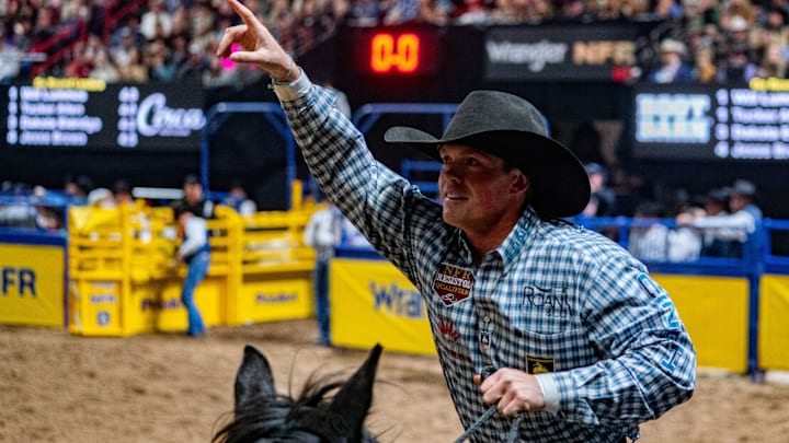 Tucker Allen taking his victory lap after splitting round four with Will Lummus at the NFR Tucker Allen taking his victory lap after splitting round four with Will Lummus at the NFR