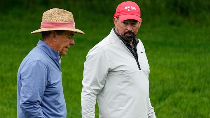 Ohio State football head coach Ryan Day talks to former Alabama football head coach Nick Saban as they walk along 14 during the Workday Golden Bear Pro-Am at Muirfield Village Golf Club in Dublin, Ohio on May 28, 2025.