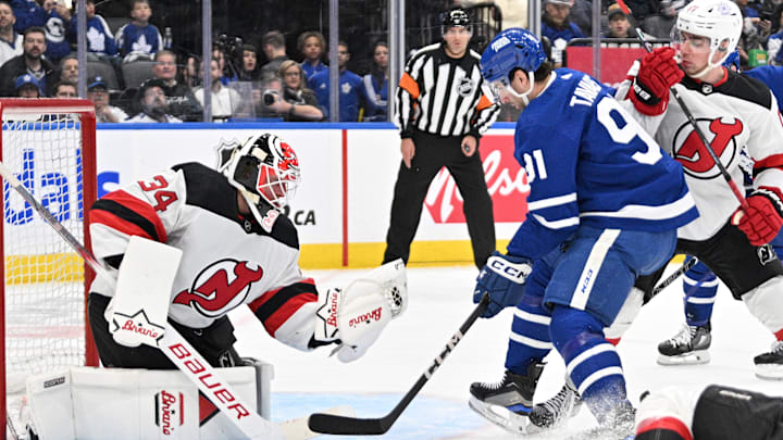 Apr 11, 2024; Toronto, Ontario, CAN; New Jersey Devils goalie Jake Allen (34) makes a glove save as Toronto Maple Leafs forward John Tavares (91) looks for a rebound in the first period at Scotiabank Arena. Mandatory Credit: Dan Hamilton-Imagn Images
