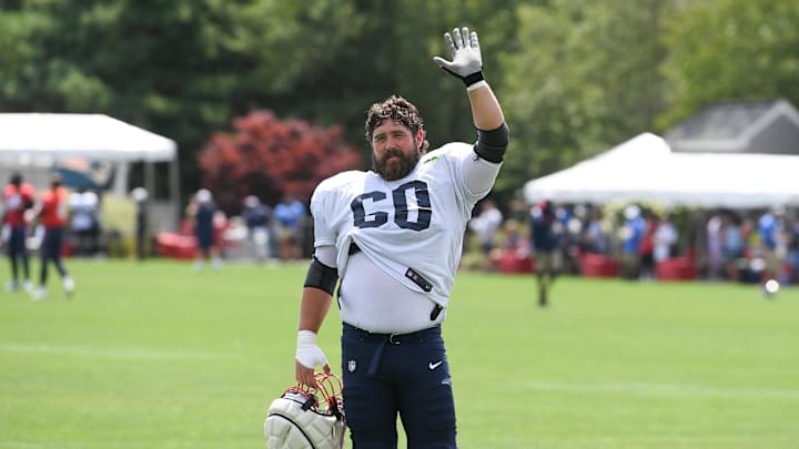 Aug 03, 2024; Foxborough, MA, USA; New England Patriots center David Andrews (60) waves to his son at training camp at Gillette Stadium. Mandatory Credit: Eric Canha-Imagn Images