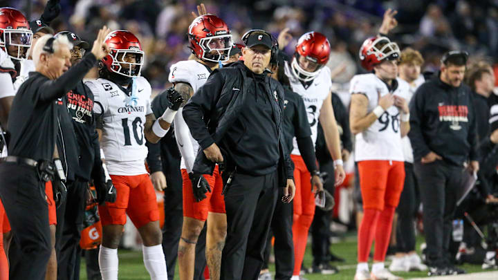 Nov 23, 2024; Manhattan, Kansas, USA; Cincinnati Bearcats head coach Scott Satterfield looks on during the fourth quarter against the Kansas State Wildcats at Bill Snyder Family Football Stadium. Mandatory Credit: Scott Sewell-Imagn Images Nov 23, 2024; Manhattan, Kansas, USA; Cincinnati Bearcats head coach Scott Satterfield looks on during the fourth quarter against the Kansas State Wildcats at Bill Snyder Family Football Stadium. Mandatory Credit: Scott Sewell-Imagn Images