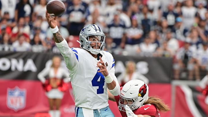 Dallas Cowboys quarterback Dak Prescott throws while being hit by Arizona Cardinals linebacker Dennis Gardeck
