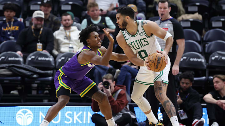 Mar 12, 2024; Salt Lake City, Utah, USA: Boston Celtics forward Jayson Tatum (0) looks to drive against Utah Jazz guard Collin Sexton (2) during the third quarter at Delta Center. Mandatory Credit: Rob Gray-Imagn Images