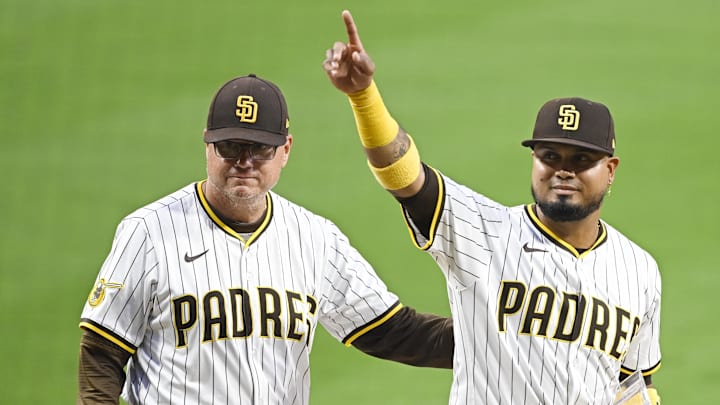 Sep 22, 2025; San Diego, California, USA; San Diego Padres first baseman Luis Arraez (4) points out the fans after receiving the San Diego Padres’ “Heart and Hustle” award from manager Mike Shildt (8) before a game against the Milwaukee Brewers at Petco Park. Mandatory Credit: Denis Poroy-Imagn Images
