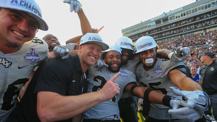 Dec 2, 2017; Orlando, FL, USA; UCF Knights head coach Scott Frost celebrates with players after defeating the Memphis Tigers in double overtime at Spectrum Stadium. Mandatory Credit: Matt Stamey-Imagn Images