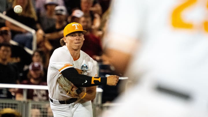 Jun 22, 2024; Omaha, NE, USA; Tennessee Volunteers third baseman Billy Amick (11) throws to first baseman Blake Burke (25) for an out against the Texas A&M Aggies during the eighth inning at Charles Schwab Field Omaha. Mandatory Credit: Dylan Widger-USA TODAY Sports