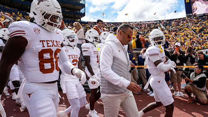 Texas head coach Steve Sarkisian and the Texas players take the field for warm up at Michigan Stadium in Ann Arbor on Saturday, September 7, 2024.