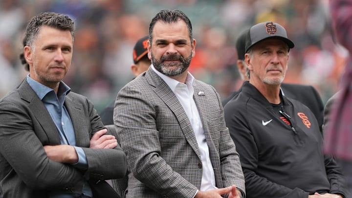 Apr 25, 2026; San Francisco, California, USA; San Francisco Giants general manager Zack Minasian (center) sits with president of baseball operation Buster Posey (left) and special assistant to baseball operations Ron Wotus (right) before the game against the Miami Marlins at Oracle Park. Mandatory Credit: Darren Yamashita-Imagn Images