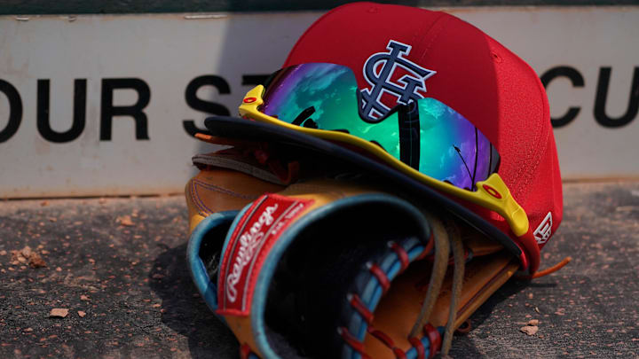 Mar 20, 2018; Jupiter, FL, USA; A St. Louis Cardinals hat with sunglasses sits on a glove in the dugout during a spring training game against the New York Mets at Roger Dean Stadium. Mandatory Credit: Jasen Vinlove-Imagn Images Mar 20, 2018; Jupiter, FL, USA; A St. Louis Cardinals hat with sunglasses sits on a glove in the dugout during a spring training game against the New York Mets at Roger Dean Stadium. Mandatory Credit: Jasen Vinlove-Imagn Images
