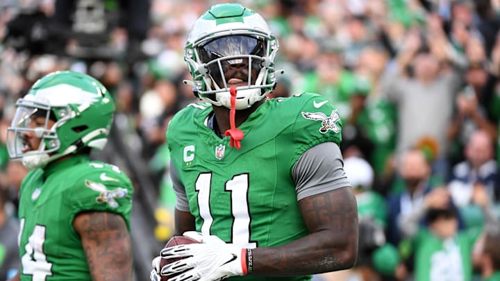Dec 29, 2024; Philadelphia, Pennsylvania, USA; Philadelphia Eagles wide receiver A.J. Brown (11) throws the football into the stands after scoring a touchdown  during the third quarter against the Dallas Cowboys at Lincoln Financial Field. Mandatory Credit: Eric Hartline-Imagn Images