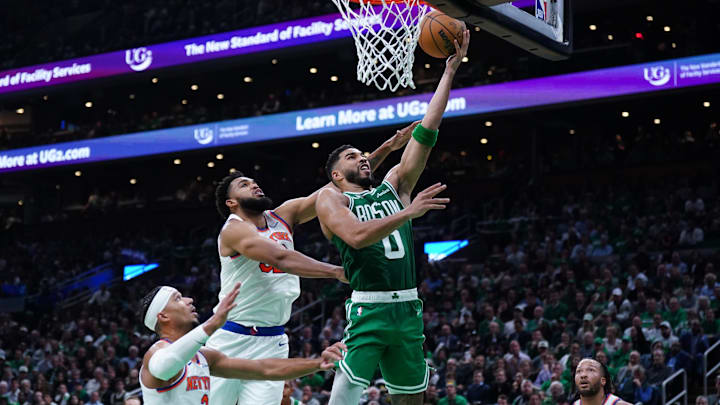 Boston Celtics forward Jayson Tatum (0) drives to the basket against New York Knicks center Karl-Anthony Towns in the second quarter at TD Garden in Boston on Oct. 22, 2024. 